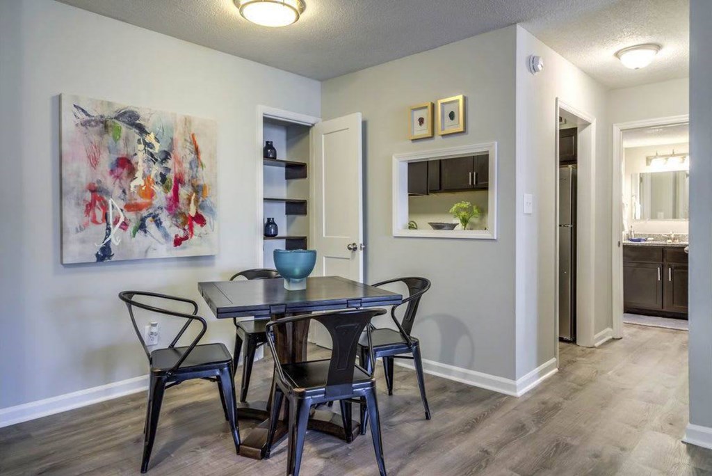A dining room with a table and chairs. A dining room with a table and chairs at The Onyx Hoover Apartments, Hoover, AL, 35216